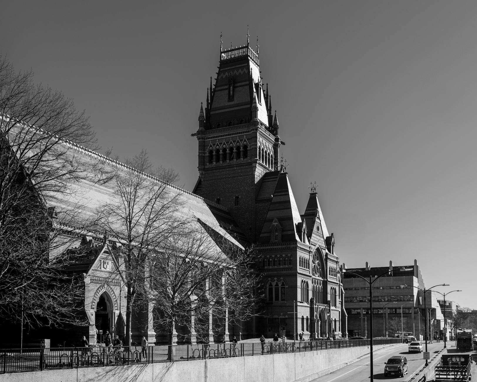 Students walk near a Harvard University campus building as federal education policy debates continue in Washington.