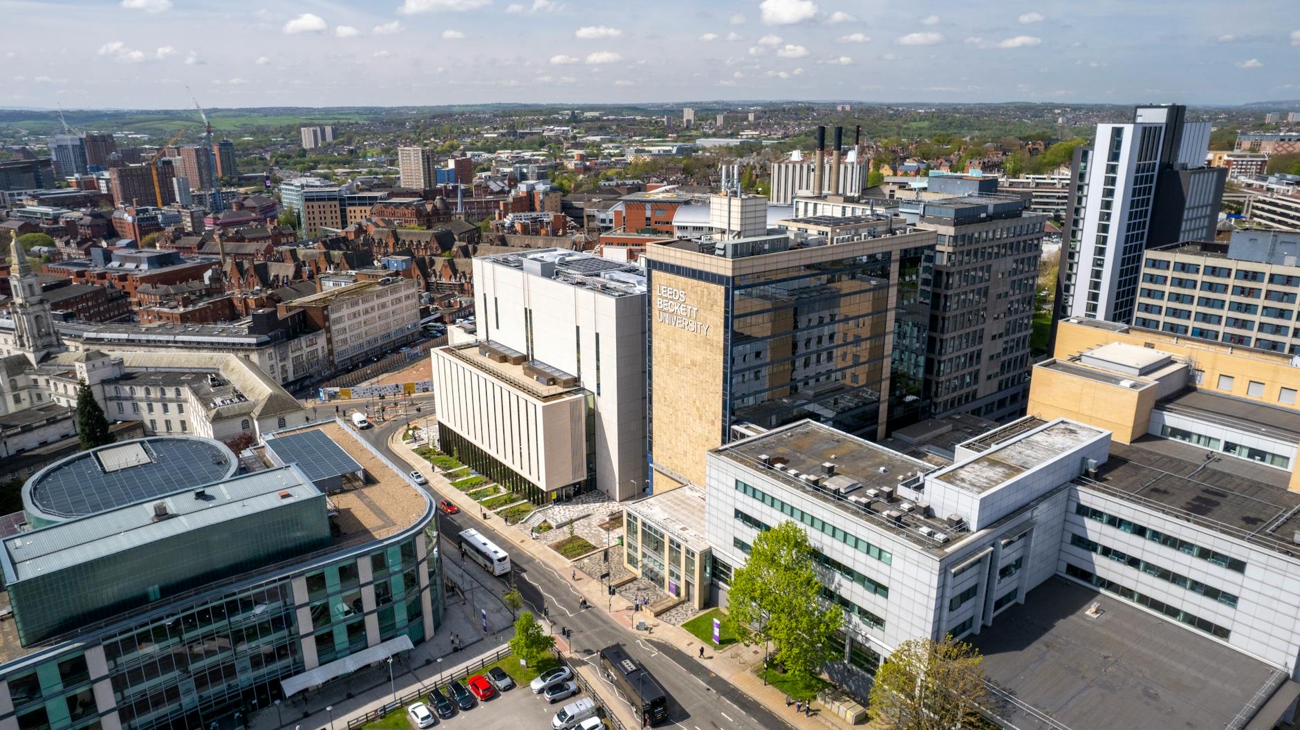 Students and staff using digital tools across a modern university campus environment