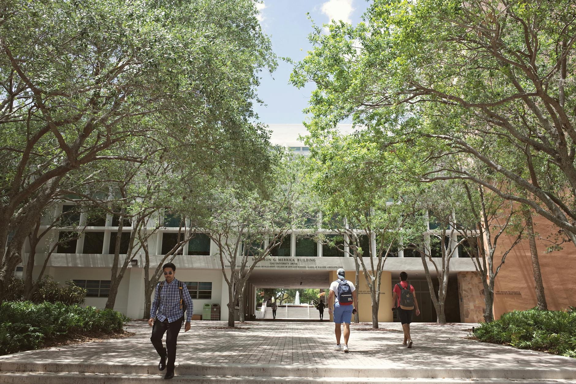 Students walk across a Colorado college campus as universities warn that state budget changes could reduce financial aid for private college students.