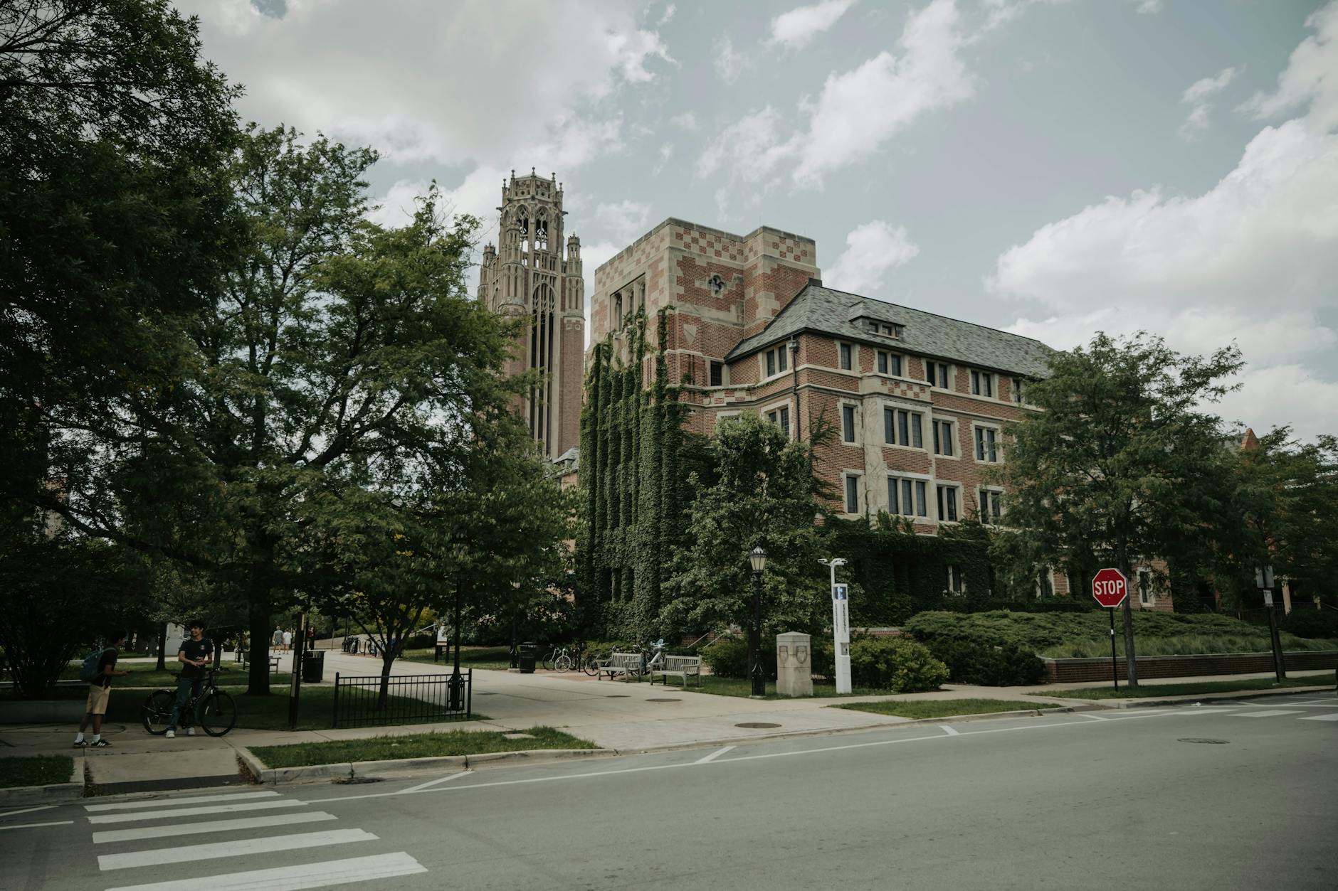 Graduate students walk across a U.S. university campus as colleges reassess international enrollment and graduate program budgets.