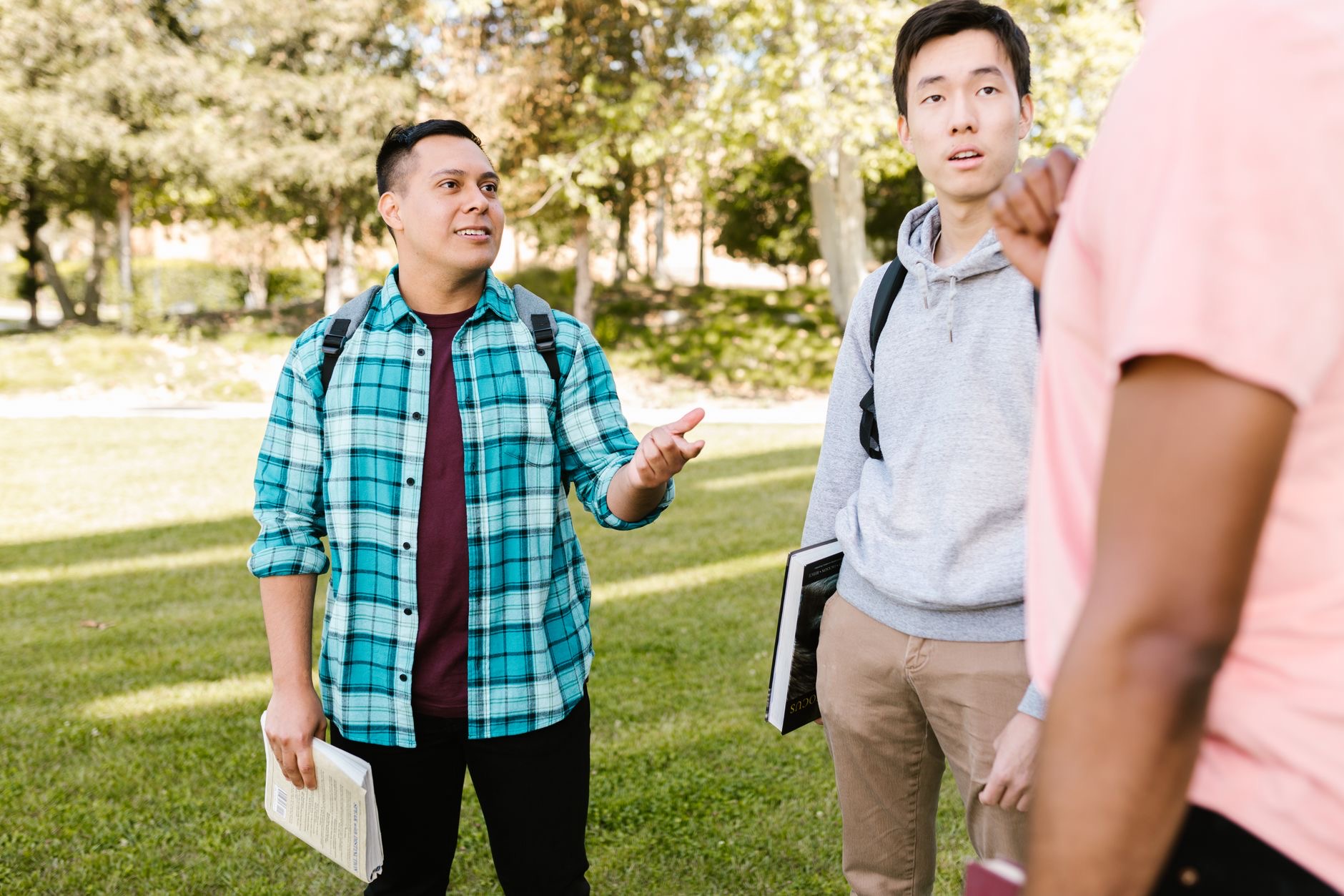 A parent and student review college savings and financial aid documents during a planning meeting.