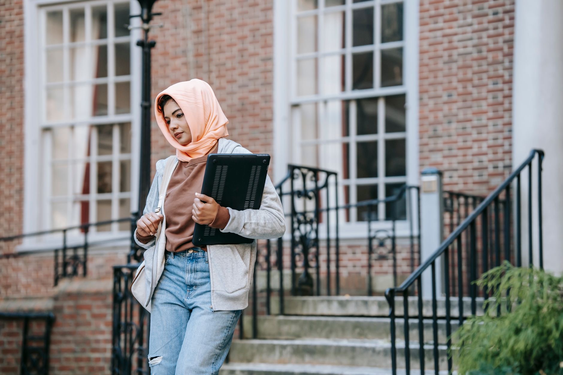 Students and faculty gather outside a university building during an interfaith education event.