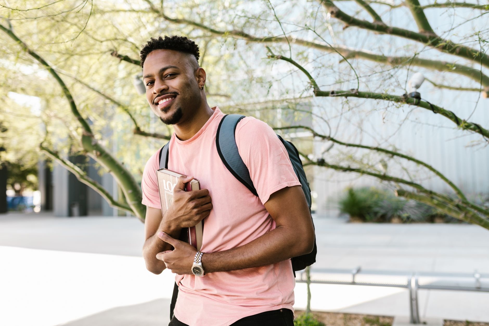 Students walk across a university campus as policymakers debate higher education funding and global rankings.