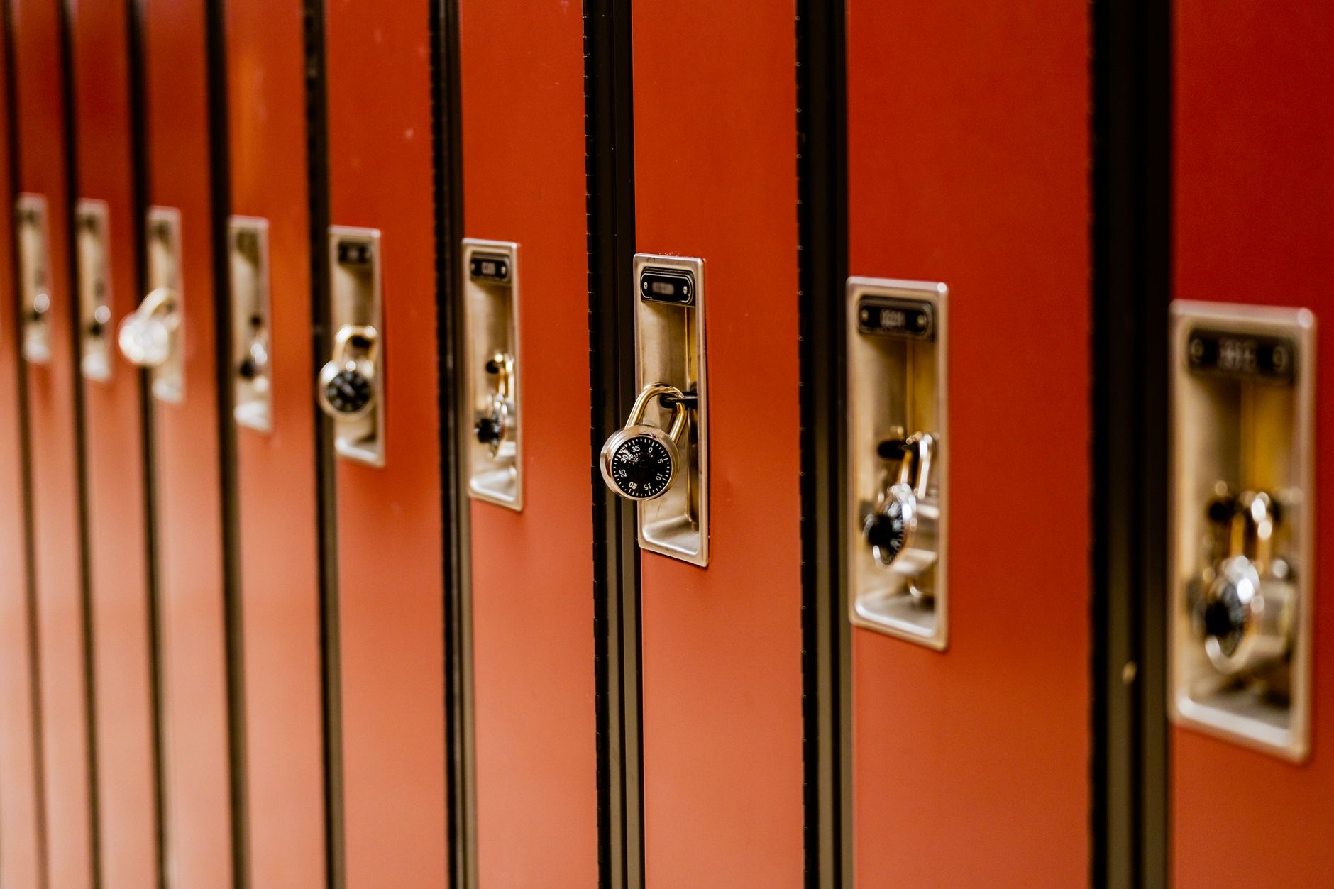 Students enter a school building near a monitored access point as institutions evaluate campus security priorities.